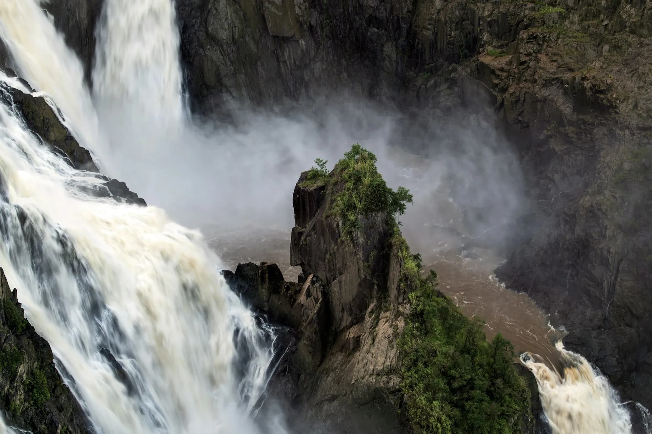 Barron Falls in full flow, surrounded by lush rainforest.