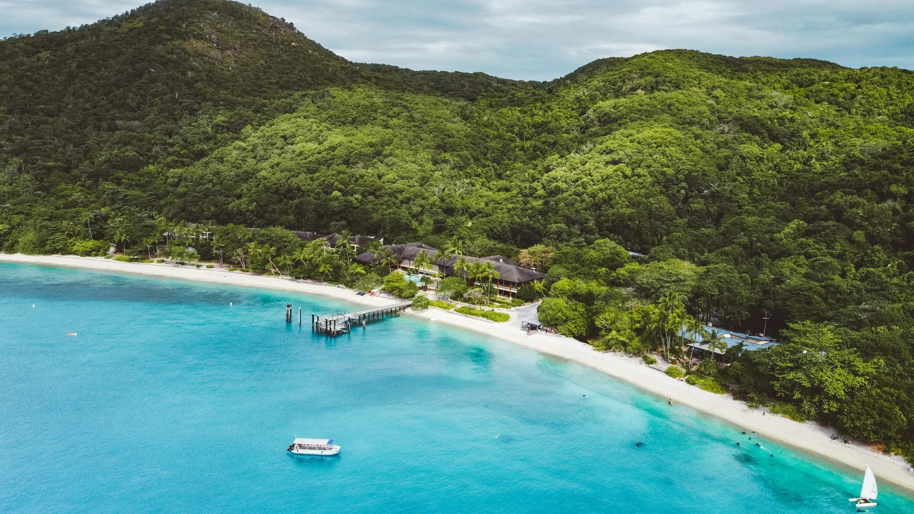 Fitzroy Island jetty, restaurant, and white sand beaches with turquoise water.
